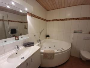 ein Badezimmer mit einer Badewanne, einem WC und einem Waschbecken in der Unterkunft Ferienwohnung Kajüte 19 in Greetsiel