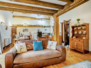 a living room with a brown couch and a kitchen at 2 bed property in Tattersett KT125 in Tattersett