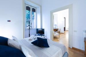 a white room with a large bed and a television at Antonelli Place in Rome