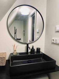 a bathroom with a black sink and a mirror at StodolA MorávkA in Morávka