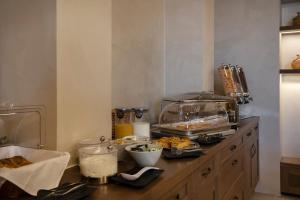 a kitchen with a counter with food on it at Μikri Arktos Boutique Hotel in Dhimitsana