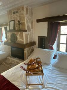 a tray of donuts on a bed in a bedroom at la foret in Metsovo