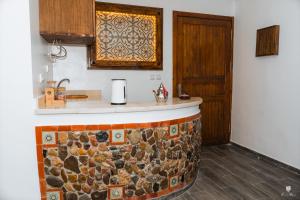 a kitchen with a counter with a stone counter top at DAR BLANCA in Chefchaouene