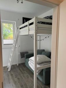 a white bunk bed with a ladder in a room at Ferienhaus Elgersburg in Elgersburg