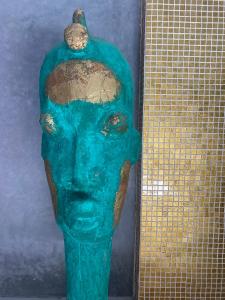 a green vase with a face on top of it at YVES Marrakech in Marrakesh