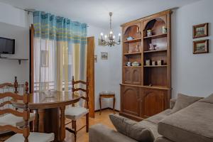 a living room with a couch and a dining room table at Via Roma 44 - YourPlace Abruzzo in Roccaraso