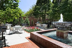 a patio with a fountain and a table and chairs at Bethesda 1br w doorman pool gym nr metro WDC-722 in Bethesda