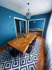 a large wooden table in a room with blue walls at Amir Apart & Hotel in Istanbul