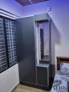 Postel nebo postele na pokoji v ubytování Maison Parnakuti Adiga's Homestay Dharmasthala Approved By KSTDC