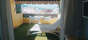 a view of a balcony with a table and chairs at Atico junto al mar in Puerto de la Cruz +19 photos