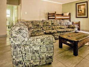 a living room with a couch and a coffee table at The Russel Guest House in Port Elizabeth