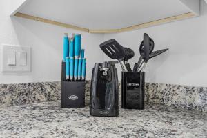 a group of utensils in a container on a counter at Villa Island Pearl - Roelens Vacations in Sanibel