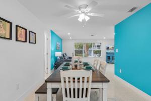 a dining room and living room with a table and chairs at Villa Island Pearl - Roelens Vacations in Sanibel