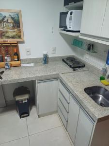 a kitchen with a sink and a counter top at Brookfield Tower in Goiânia