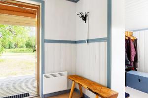 a room with a bench next to a door at Cozy cottage on a large natural plot in lovely Harjedalen in Vemdalen