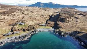 an aerial view of a mountain with a body of water at Doune Bay Lodge 