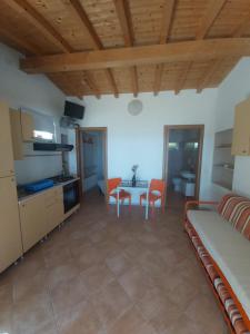 a living room with a bed and a table at Villaggio Turistico dei Tigli in Padenghe sul Garda