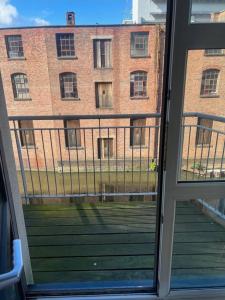 a view of a brick building from a window at City Centre Apartment - Sleeps 5 in Nottingham