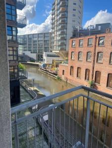a view of a river in a city with buildings at City Centre Apartment - Sleeps 5 in Nottingham