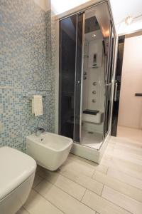 a bathroom with a shower and a toilet and a sink at Bnbook Bilo Conciliazione in Rho