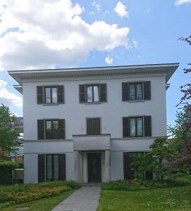 a white house with black windows and a driveway at Architekten Villa in Theaternähe in Meiningen