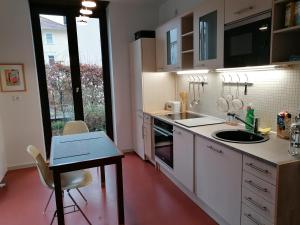 a kitchen with a sink and a table and a counter at Architekten Villa in Theaternähe in Meiningen