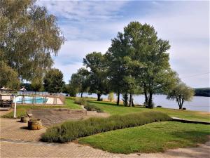 een park met een speeltuin en bomen en water bij Camping le Caussanel in Canet-de-Salars