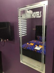 a reflection of a bed in a mirror in a room at MAVINIK'S (Ogun State) HOTEL, SUITES AND LOUNGE in Otta