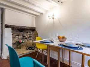 a dining room with a table and yellow chairs at 3 Bed in Bourton on the Water 75532 in Bourton on the Water