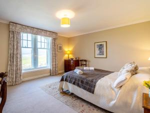 a bedroom with a bed and a large window at 5 bed property in Machrihanish CA291 in Machrihanish