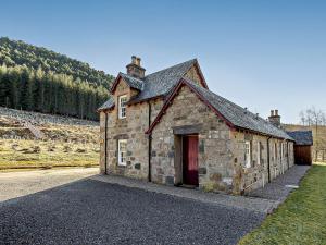 an old stone building on the side of a road at 1 Bed in Alness CA015 in Boath