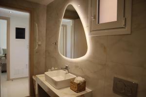 a bathroom with a sink and a mirror at Merelia Luxury Guesthouse in Haraki