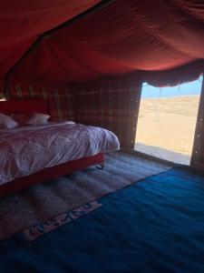 a bedroom with a bed in a tent at Clouds Desert Camp in Badīyah