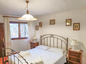 a bedroom with a white bed and a window at Villa Alice e Silvia - Chia in Chia