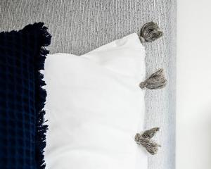 a white pillow with two butterflies on top of it at Chic 1 Bedroom Flat in Bedford