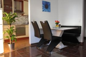a kitchen with a table and chairs in a kitchen at Ferienwohnung Novotny in Lörrach