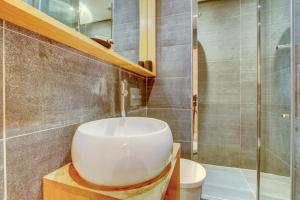 a bathroom with a white sink and a shower at AUBERGE 1 in Morzine