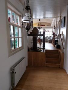 a living room with a hallway with a table and a window at Pakhuys bij de Zaanse Schans in Zaandijk