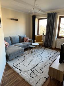 a living room with a couch and a rug at Apartament Wałbrzych in Wałbrzych