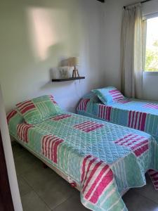 two beds sitting next to each other in a bedroom at Firenze Cabañas - Playa Chapadmalal in Chapadmalal +6 photos