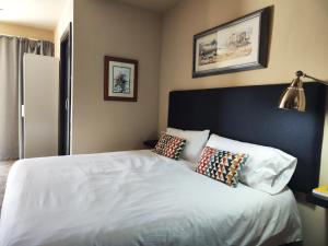 a bedroom with a white bed with two pillows at Casa Natalia in Tías +33 photos