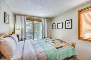 a bedroom with a bed and a window at Ski-InandSki-Out Winter Park Condo with Mountain Views in Winter Park +26 photos