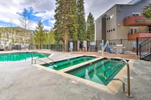 a swimming pool in front of a house at Ski-InandSki-Out Winter Park Condo with Mountain Views in Winter Park