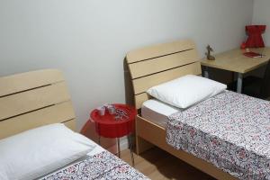 a small room with two beds and a desk at Metro House in Site, Next to the Shopping Mall in Sarıgazi