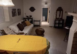 uma sala de estar com uma mesa amarela e um sofá em Monte da Clareira - Comporta Carvalhal Melides em Grândola