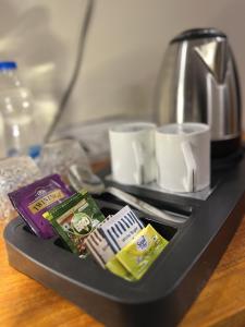 a tray with tea packets and a coffee maker at House Of Ubuntu in Rāmtek