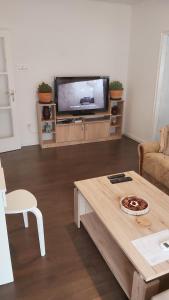 a living room with a tv and a coffee table at Mikesh in Virovitica