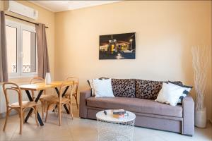 a living room with a couch and a table at Helianthus Apartments in Argostoli