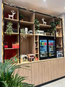 a store front with plants on the shelves at Holiday Inn Express Antwerp - City Centre, an IHG Hotel in Antwerp