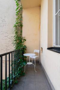 a table and chairs sitting on a balcony at Retro Apartmentments Łobzowska street in Kraków